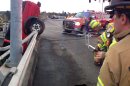 This image provided by the Beaverton Police Department shows a red pickup truck dangling from the Denney Road overpass near highway 217 outside Beaverton, Oregon as emergency workers respond to the scene Saturday afternoon Nov. 24, 2012. The driver has been identified as Matthew Alan Hamilton 38 years old of Beaverton. He was taken to the hospital with unkown injuries after being plucked from the truck by firefighters. Hamilton has been arrested for DUI, driving while suspended for a previous misdemeanor DUI. (AP Photo/Beaverton Police Department)