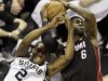 San Antonio Spurs' Kawhi Leonard (2) and Miami Heat's LeBron James (6) battle for a rebound during the first half at Game 4 of the NBA Finals basketball series, Thursday, June 13, 2013, in San Antonio. (AP Photo/David J. Phillip)