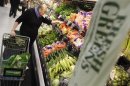 A shopper looks through the produce section in a newly opened Walmart Neighborhood Market in Chicago