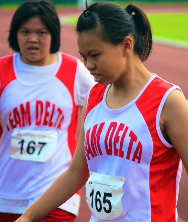 Young Lee Zheng Lok, exhausted after the effort she put into her race. (Photo: Special Olympics Singapore)