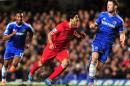 Luiz Suarez (centre) clashes with Chelsea's Gary Cahill during the Premier League game at Stamford Bridge in London on December 29, 2013