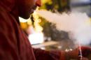 A customer puffs on an e-cigarette at the Henley Vaporium in New York City