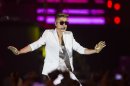FILE - A Sunday, March 31, 2013 photo from files showing Canadian singer Justin Bieber performing on stage during the "I Believe Tour " in Berlin, Germany. Swedish police say they have found drugs on board a tour bus used by Canadian pop singer Justin Bieber. Police spokesman Lars Bystrom says a small amount of drugs and a stun gun were found when officers raided the empty bus parked under the Globen concert venue in Stockholm, where Bieber was performing Wednesday, April 24, 2013. (AP Photo/Gero Breloer)