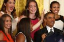 Dolson puts bunny ears over U.S. President Obama during ceremony to honor the team in the East Room at the White House in Washington