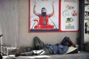 An Indian man rests in the shade to escape soaring &hellip;