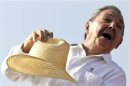 Cuba's President Raul Castro puts his hat on after waving to the crowd at the annual May Day parade at Havana's Revolution Square