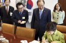 In this May 6, 2013 photo, South Korean President's spokesman Yoon Chang-jung, third right top, watches South Korean President Park Geun-hye, right bottom, sign the guestbook as UN Secretary General Ban Ki-moon, second right, looks on, at United Nations headquarters. President Park's office says she has fired her chief spokesman Yoon after a 