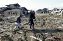 Family visit the spot where their house, washed away by the March 11, 2011 tsunami, used to stand in Higashimatsushima