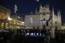 People gather in Duomo Square as Five-Star Movement activist and comedian Grillo speaks during a rally in Milan