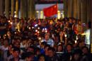 Anti-Occupy protesters hold candles and a Chinese flag as they gather to oppose actions of pro-democracy groups in Hong Kong