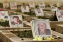 Pictures of Houthi followers are seen on their graves at a cemetery dedicated for Houthis killed in Yemen's ongoing conflict, in Sanaa