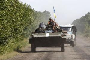 Ukrainian servicemen drive a military armoured vehicle …