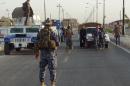 Iraqi security forces man a checkpoint in the northern city of Kirkuk on October 1, 2014