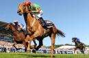 Dancing Rain, (Foreground) ridden by jockey Johnny Murtage crosses the line in first place to win The Investec Oaks race on Ladies Day, the first day of the Epsom Derby Festival, in Surrey, southern England, on June 3, 2011