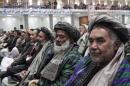 Members of the Afghan Loya Jirga attend a meeting in Kabul, Afghanistan, Thursday, Nov. 21, 2013. Afghan President Hamid Karzai has told a gathering of elders that he supports signing a security deal with the United States if safety and security conditions are met. Karzai spoke as the 2,500-member national consultative council of Afghan elders known as the Loya Jirga started in Kabul on Thursday. The four-day meeting will discuss the bilateral security pact that defines the role of thousands of U.S. troops who will remain after the NATO combat mission ends in 2014. (AP Photo/Rahmat Gul)