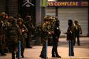 French soldiers and members of police special forces stand guard in the northern Paris suburb of Saint-Denis city center, on November 18, 2015, during an anti-terror operation