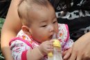 A Chinese baby drinks coconut milk mixed with water instead of baby formula