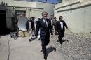 Afghanistan's presidential candidate Abdullah Abdullah, center, arrives for a news conference in Kabul, Afghanistan, Wednesday, June 18, 2014. The front-runner in Afghanistan's runoff presidential election has called for vote counting to stop over fraud claims. (AP Photo/Massoud Hossaini)