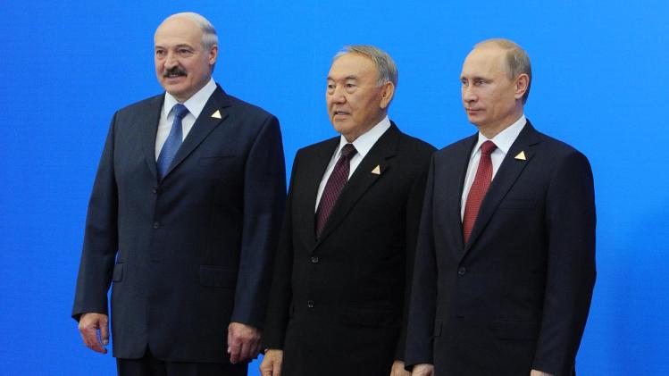From left: Belarus President, Alexander Lukashenko, Kazakhstan&#39;s President, Nursultan Nazarbayev and Russian President, Vladimir Putin, pose for a photo after they agreed to create the Eurasian Economic Union, an alliance intended to further boost economic and trade ties between the ex-Soviet neighbors in Astana, Kazakhstan, Thursday, May 29, 2014. The new alliance is the development of the Customs Union including the same nations. In addition to free trade, it coordinates the members&#39; financial systems and regulates industrial and agricultural policies along with their labor markets and transport systems. (AP Photo/RIA Novosti Kremlin, Mikhail Klimentyev, Presidential Press Service, Pool)