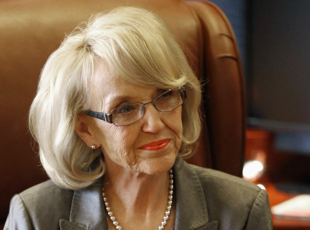 FILE - This Jan. 10, 2013 file photo show Arizona Gov. Jan Brewer in her office at the Capitol in Phoenix. Governors who reject health insurance for the poor under the federal health care overhaul could wind up in a politically awkward position on immigration: A quirk in the law means some U.S. citizens would be forced to go without coverage, while legal immigrants residing in the same state could still get it. Arizona officials called attention to the problem last week, when Brewer announced she would accept the expansion of Medicaid offered under Obama’s law. Brewer had been a leading opponent of the overhaul, and her decision got widespread attention. Budget documents cited the immigration glitch as one of her reasons. (AP Photo/Matt York, File)