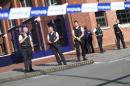 Police stand as they secure the area around a police building in the southern Belgian city of Charleroi following a machete attack on August 6, 2016