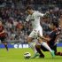 Real Madrid's Ozil is fouled by Celta Vigo's Cabral during their Spanish First Division soccer match at Santiago Bernabeu stadium in Madrid