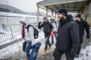 Refugees and migrants walk to cross the Slovenian-Austrian border on January 5, 2016 in Sentilj