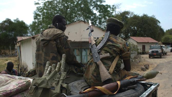 South Sudanese People Liberation Army (SPLA) soldiers sit on a pick up truck during a patrol in Malakal on January 21, 2014