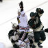 Chicago Blackhawks' Patrick Sharp, center, celebrates his goal off Minnesota Wild goalie Josh Harding, left, in the first period of Game 4 of an NHL hockey Stanley Cup playoff series, Tuesday, May 7, 2013 in St. Paul, Minn. At right is Wild's Jared Spurgeon (AP Photo/Jim Mone)