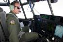 RAAF Pilot Flight Lieutenant Brett pilots a RAAF C-130J Hercules airc as it prepares to launch two Self Locating Data Marker Buoys in the southern Indian Ocean during the search for missing Malaysian Airlines flight MH370