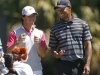 File of McIlroy of Northern Ireland sharing a laugh with his playing partner Tiger Woods at Doral