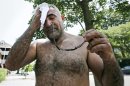 House painter Jesus Rubela wipes the sweat from his face while restoring a home in the South Boston neighborhood, Wednesday, July 17, 2013 in Boston. Temperatures in the Boston area reached the 90's, extending a heat wave. (AP Photo/Charles Krupa)
