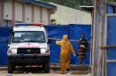 A patient steps out of an ambulance on November 11, 2014 upon her arrival at the Hastings treatment center outside Freetown