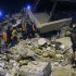 Rescuers search for survivors in the rubble of a collapsed hotel in Van, eastern Turkey, late Wednesday, Nov. 9, 2011.  An earthquake struck eastern Turkey on Wednesday night, killing at least three people and leaving dozens trapped in the rubble of toppled buildings damaged in the previous temblor, which had killed 600 people. About 20 buildings collapsed in the provincial capital of Van following a 5.7-magnitude quake, according to media reports.(AP Photo/Evrim Aydin, Anatolia) TURKEY OUT