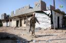 An Iraqi soldier walks through Jurf al-Sakhr after regime forces retook the town from Islamic State militants on October 27, 2014