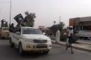 An image grab, taken from a video uploaded on Youtube on June 17, 2014, allegedly shows militants from the Islamic State group parading in the northern city of Baiji, Iraq