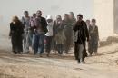 Iraqis walk as they flee their neighbourhoods to safer locations on November 28, 2016 in an eastern district of the city of Mosul during the ongoing figthing between Islamic State (IS) group jihadists and government forces