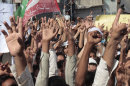 Supporters of a Pakistani Tehreek-e-Insaf or Movement for Justice chant slogans during a demonstration in Peshawar, Pakistan, Sunday, Sept. 16, 2012, as part of widespread anger across the Muslim world about a film ridiculing Islam's Prophet Muhammad. (AP Photo/Muhammad Sajjad)