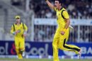 Australian bowler Mitchell Starc celebrates after taking the wicket of Pakistani batsman Umar Akmal