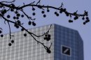 The logo of Germany's largest business bank, Deutsche Bank, is seen at the bank's headquarters behind twigs in Frankfurt