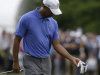 Tiger Woods looks at his wrist after a shot on the first hole during the first round of the U.S. Open golf tournament at Merion Golf Club, Thursday, June 13, 2013, in Ardmore, Pa. (AP Photo/Gene J. Puskar)