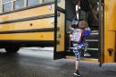 FILE - In this Sept. 4, 2012 file photo, a student at Indian Lake Elementary in Kalamazoo, Mich., boards a bus on the first day of school. Bullying is a 