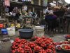 A woman waits for customer at a local food market after the suspension of a nationwide strike, in Lagos