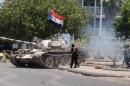 A tank bearing the flag of southern Yemeni seperatist movement, which was confiscated from a military depot, is driven on a street in the southern city of Aden on March 27, 2015