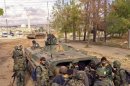 Forces loyal to Syria's President Assad prepare for operations in areas controlled by the Free Syrian Army fighters, in Aleppo