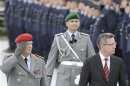 German Defence Minister de Maiziere and Chief of Staff of the German Military General Wieker inspect the guard of honour in Berlin