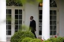 U.S. President Barack Obama walks towards the Oval Office at the White House in Washington