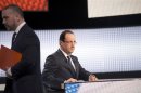 France's President Hollande sits with his notes before appearing on France 2 television prime time news broadcast for an interview at their studios in Paris