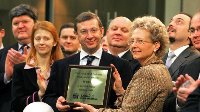 Vladimir Yevtushenkov (C), president of Sistema, receives a welcome plaque at the London Stock Exchange on February 14, 2005