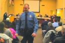 FILE - In this Feb. 11, 2014 file image from video released by the City of Ferguson, Mo., officer Darren Wilson attends a city council meeting in Ferguson. Wilson has told authorities that Michael Brown reached for the gun during a scuffle, the Times reported in a story posted on its website Friday night Oct. 17, 2014. (AP Photo/City of Ferguson, File)